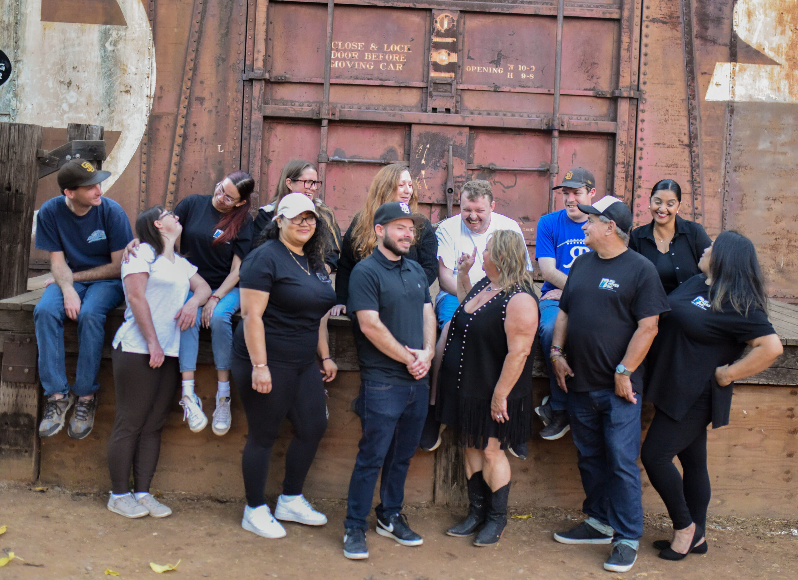 The Big Moves Inc. team and clients laughing together outdoors