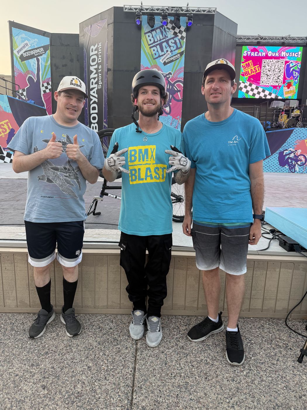 Two Big Moves clients meeting a rider at a community BMX show