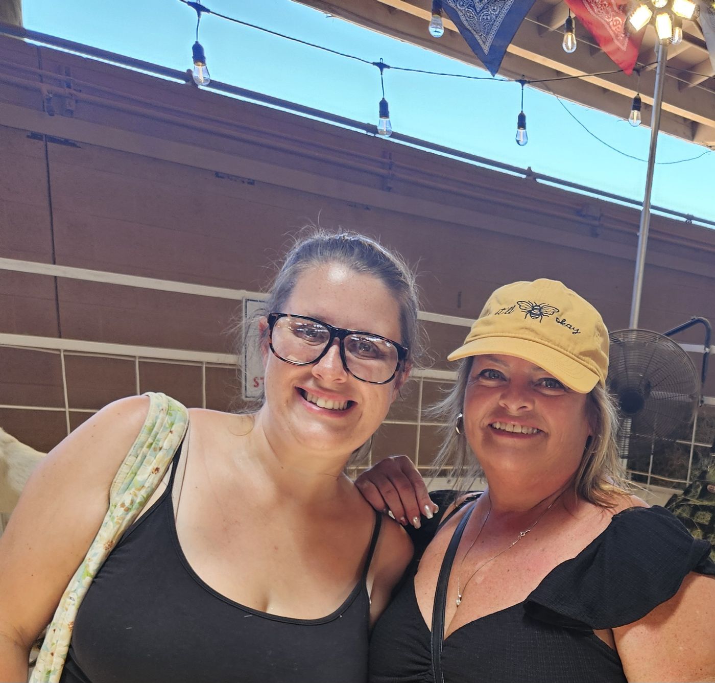 Two members of the Big Moves family smiling together on a sunny patio