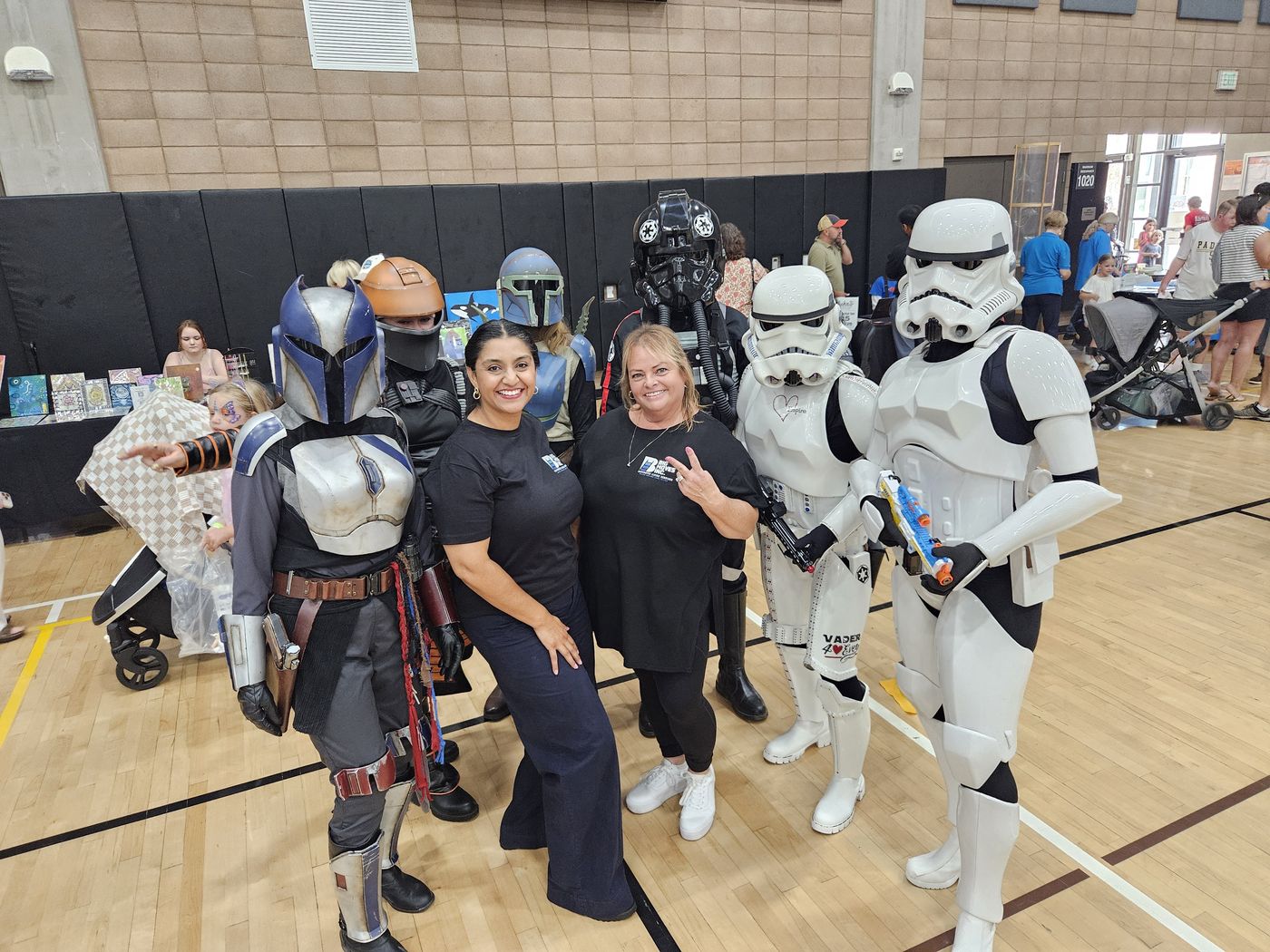 Big Moves staff posing with costumed Star Wars characters at a community resource fair