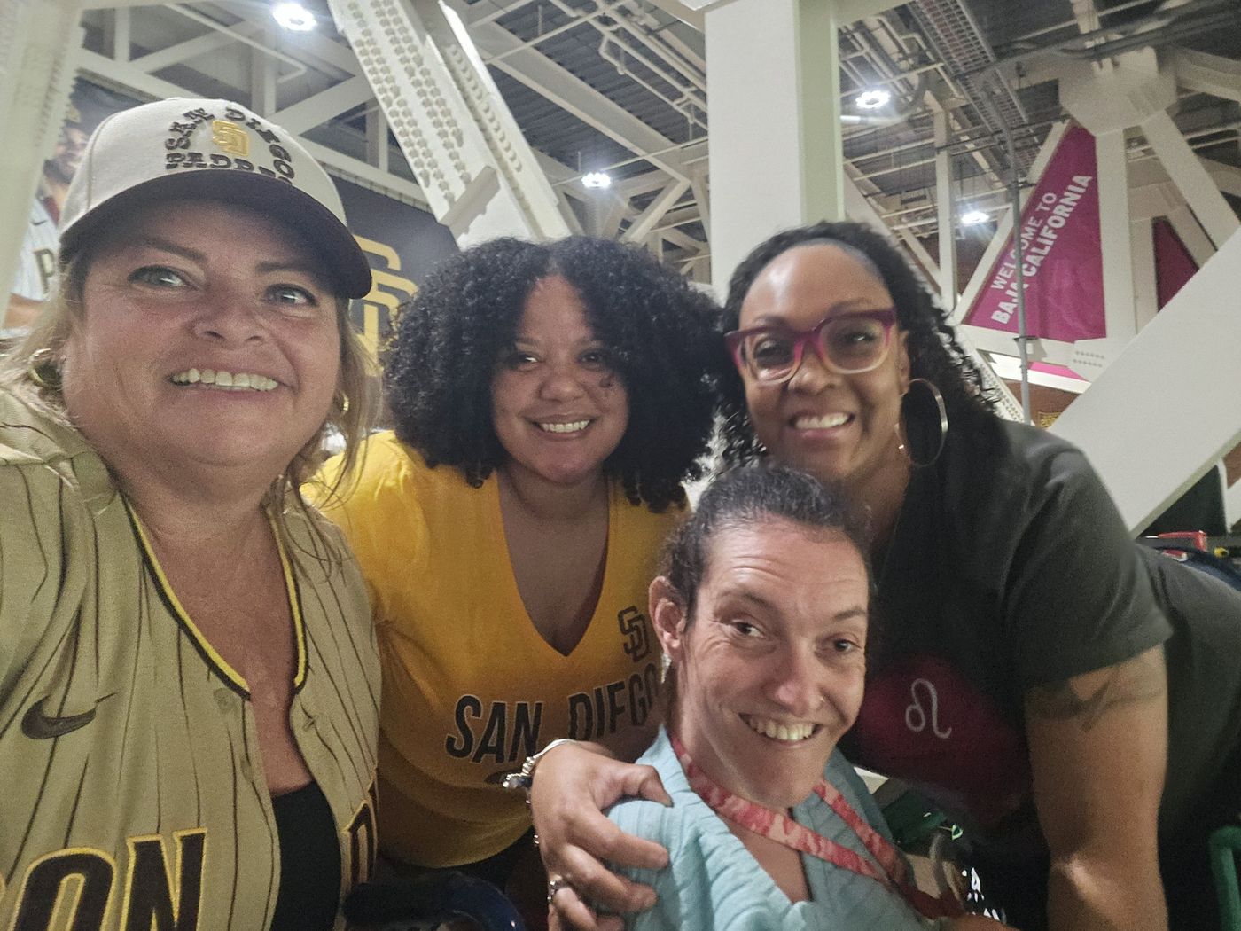 Four members of the Big Moves family smiling together at a San Diego Padres game