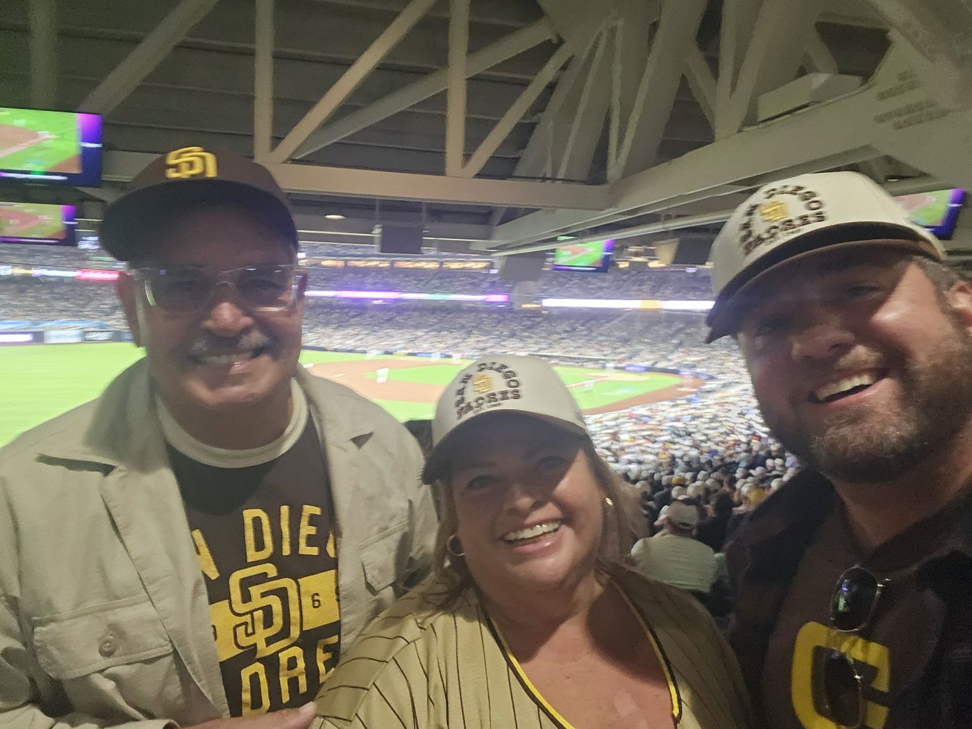 Three members of the Big Moves family watching a Padres game from the stands